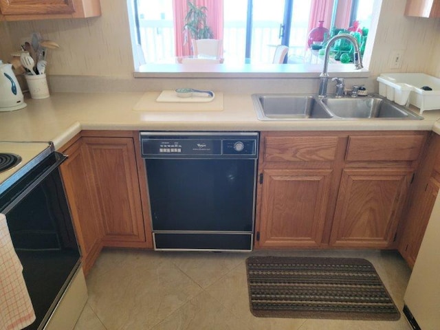 kitchen featuring a sink, black dishwasher, electric range oven, brown cabinetry, and light countertops