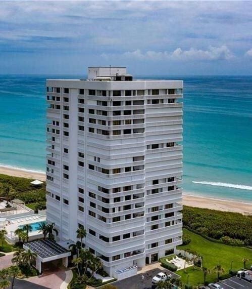 view of building exterior with a view of the beach and a water view