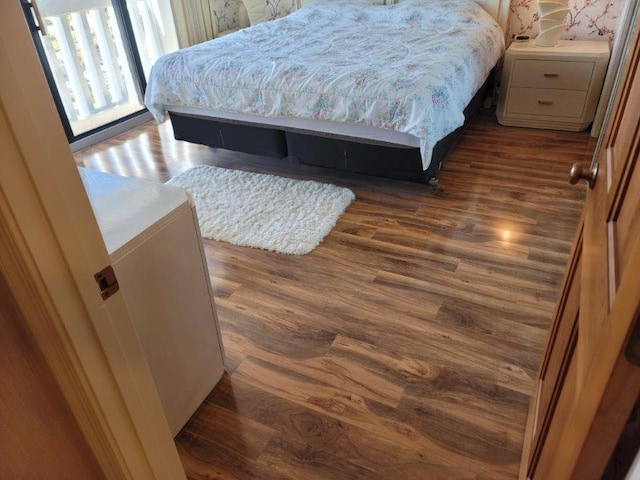 bedroom with dark hardwood / wood-style flooring