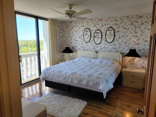 bedroom with a ceiling fan, wood finished floors, wallpapered walls, a textured ceiling, and access to outside