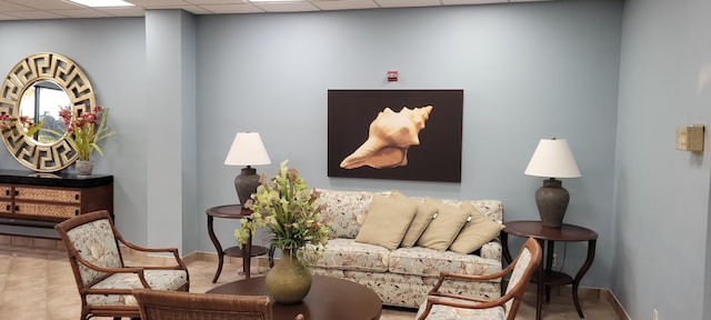 living area featuring a paneled ceiling