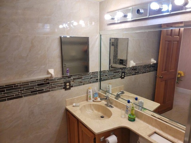 bathroom with backsplash, tile walls, and vanity