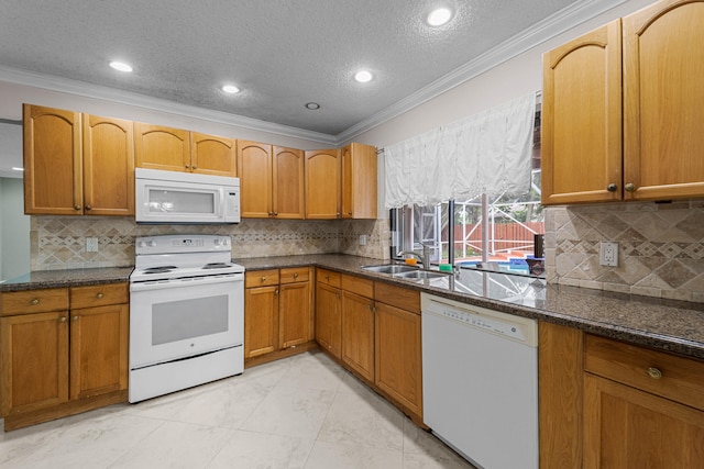 kitchen featuring white appliances, a textured ceiling, dark stone counters, and ornamental molding