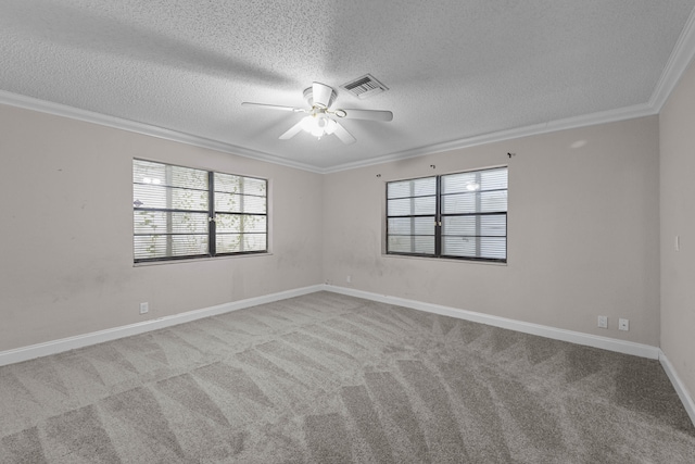 empty room with ceiling fan, light colored carpet, ornamental molding, and a textured ceiling