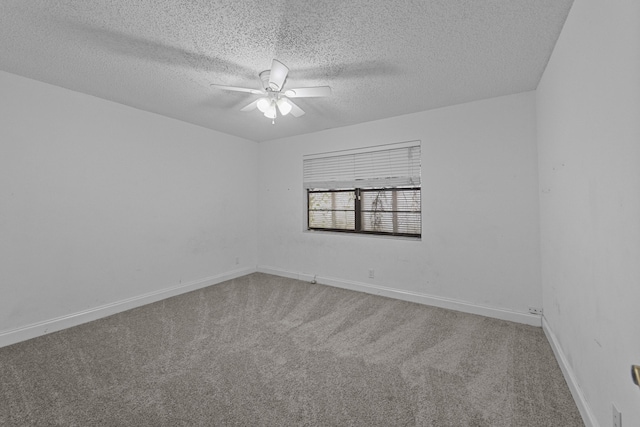 carpeted spare room with ceiling fan and a textured ceiling