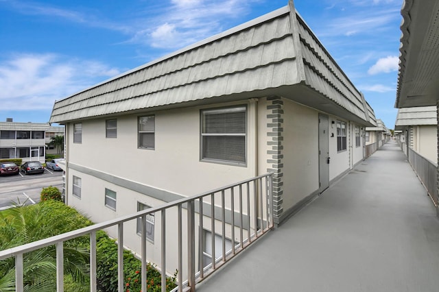 view of side of home with a balcony