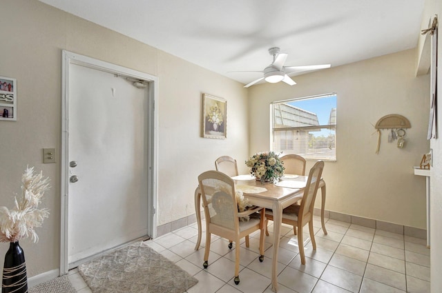 tiled dining room featuring ceiling fan