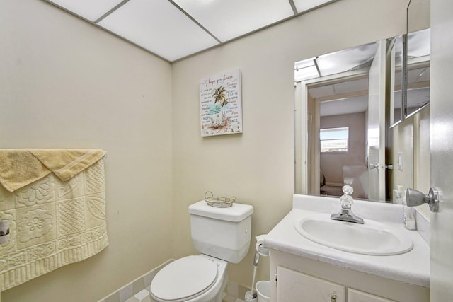 bathroom with tile patterned floors, vanity, and toilet