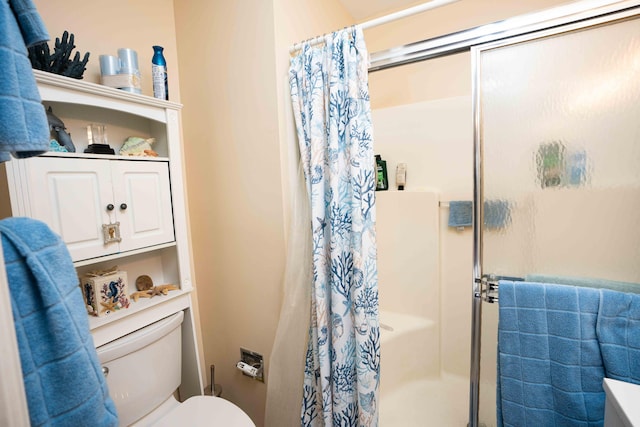 bathroom featuring a shower and toilet