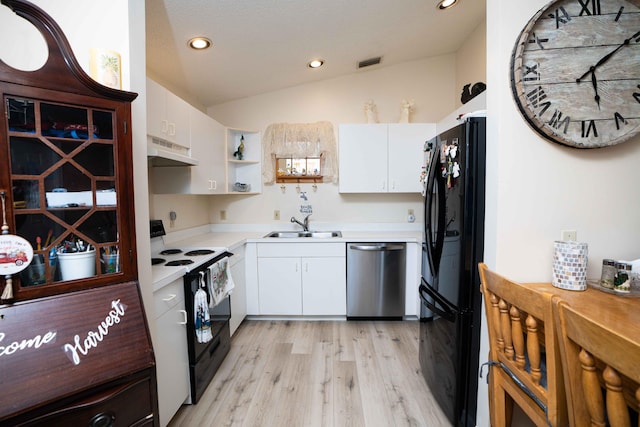 kitchen with white cabinets, premium range hood, vaulted ceiling, and black appliances