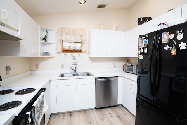 kitchen featuring dishwasher, black refrigerator, white cabinets, and sink