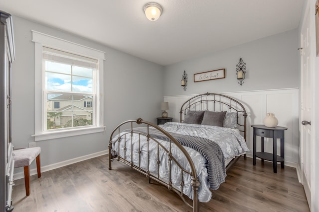 bedroom with dark hardwood / wood-style flooring