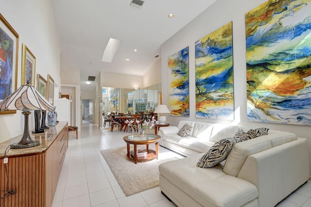 living area featuring light tile patterned floors, high vaulted ceiling, and visible vents