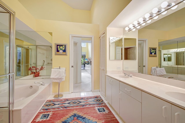 bathroom featuring double vanity, a stall shower, a sink, tile patterned flooring, and a bath