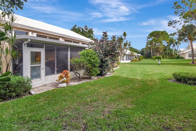 view of yard featuring a sunroom