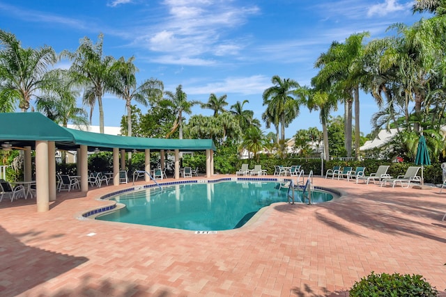 pool featuring a patio area and fence