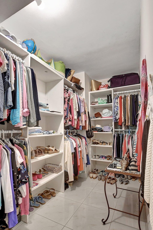 spacious closet featuring light tile patterned flooring