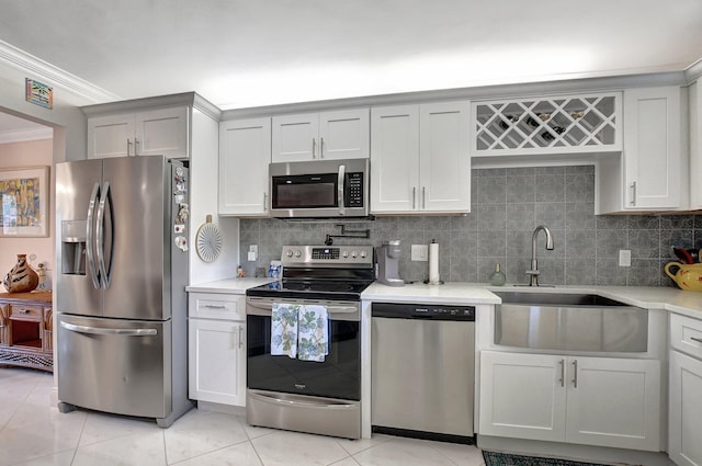 kitchen featuring decorative backsplash, sink, light tile patterned floors, and stainless steel appliances