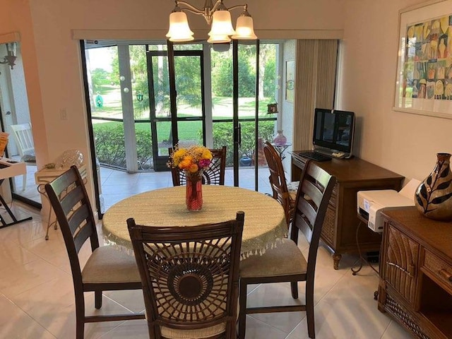 tiled dining space featuring a chandelier