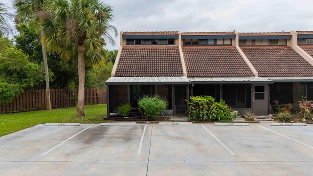 rear view of house featuring a yard