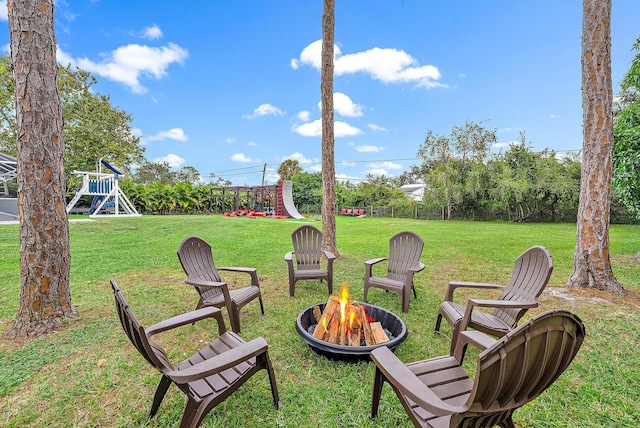 view of yard featuring a fire pit and a playground