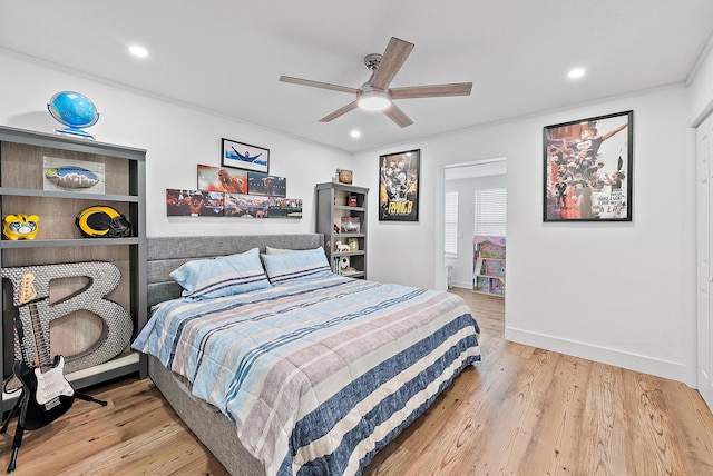 bedroom featuring ceiling fan, light hardwood / wood-style floors, and ornamental molding