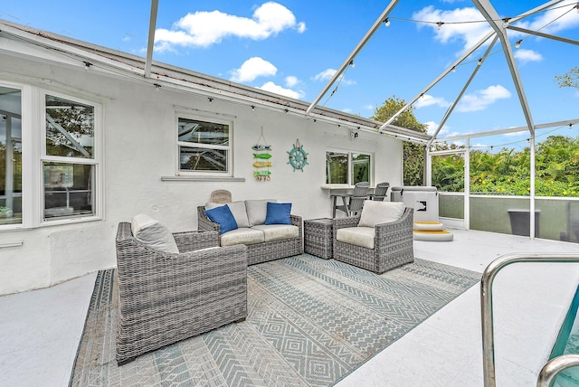 view of patio / terrace with an outdoor hangout area and glass enclosure