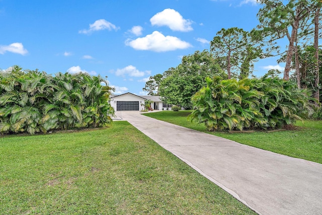 view of front of property featuring a garage and a front lawn