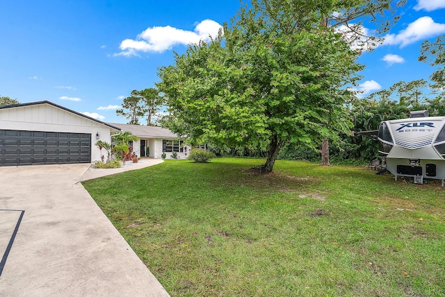 view of front of house with a front yard and a garage