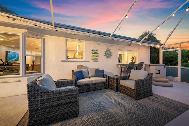 patio terrace at dusk featuring an outdoor living space