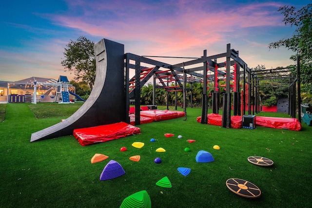 playground at dusk featuring a yard