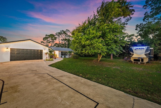 view of front of house featuring a garage and a yard