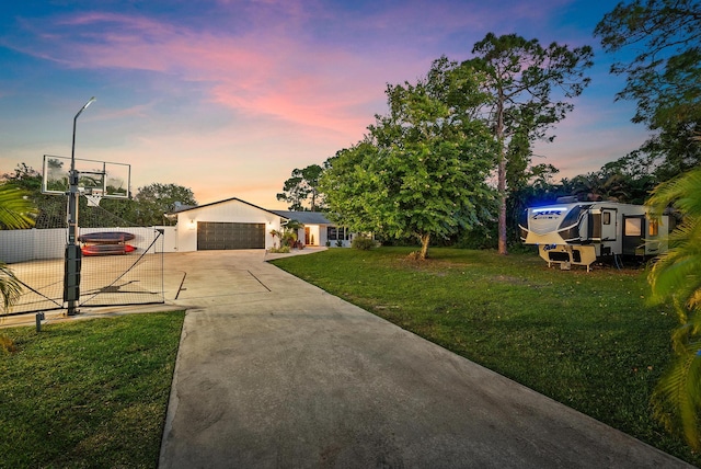 view of front of property with solar panels, a yard, and a garage