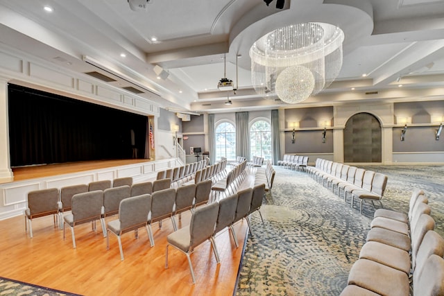 home theater room featuring hardwood / wood-style flooring and a tray ceiling