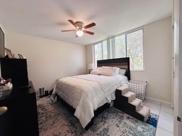 tiled bedroom featuring ceiling fan