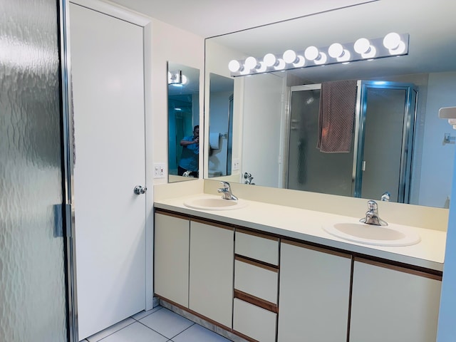 bathroom featuring vanity, tile patterned floors, and a shower with shower door