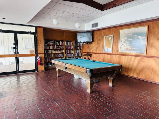 game room featuring pool table and wood walls