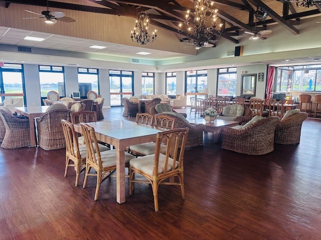 dining space featuring beam ceiling, dark hardwood / wood-style floors, high vaulted ceiling, and a wealth of natural light