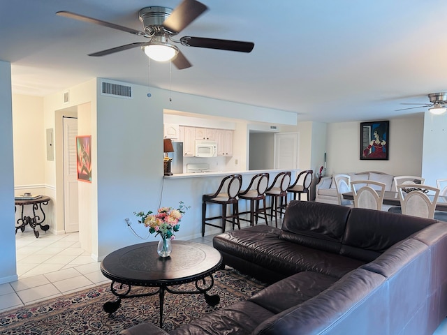 living room with ceiling fan and light tile patterned floors