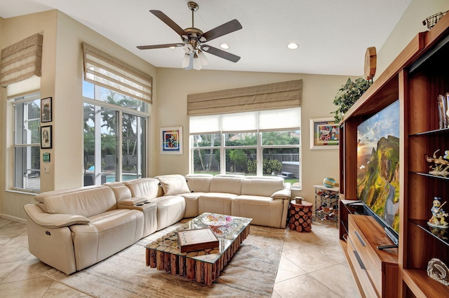 living room featuring ceiling fan, light tile patterned floors, and lofted ceiling