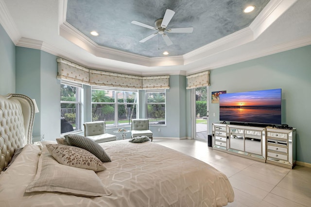 tiled bedroom featuring a tray ceiling, multiple windows, crown molding, and ceiling fan