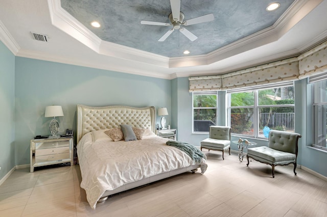 bedroom featuring a raised ceiling, ceiling fan, and ornamental molding