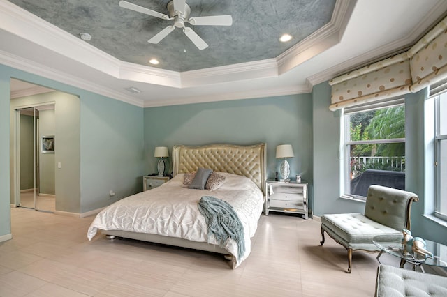 bedroom featuring a raised ceiling, ceiling fan, and crown molding