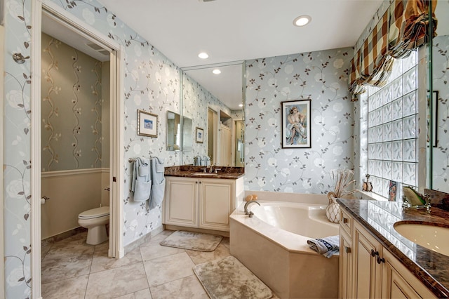 bathroom featuring a tub, tile patterned flooring, vanity, and toilet