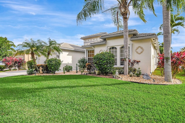 mediterranean / spanish home featuring a front yard