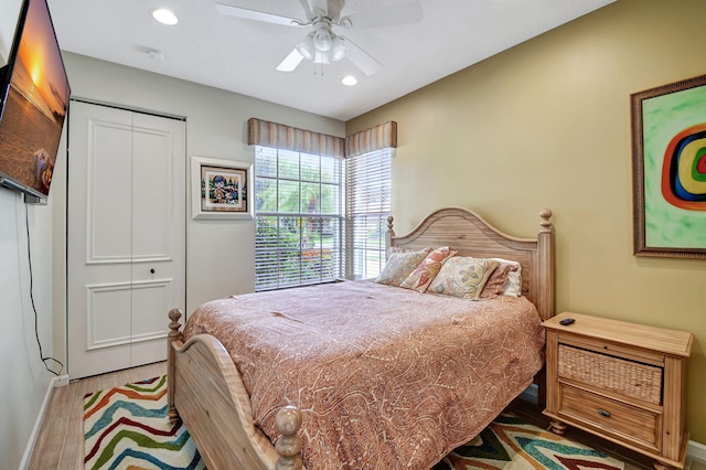 bedroom with ceiling fan, a closet, and hardwood / wood-style floors