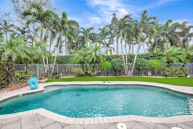 view of pool featuring a lawn