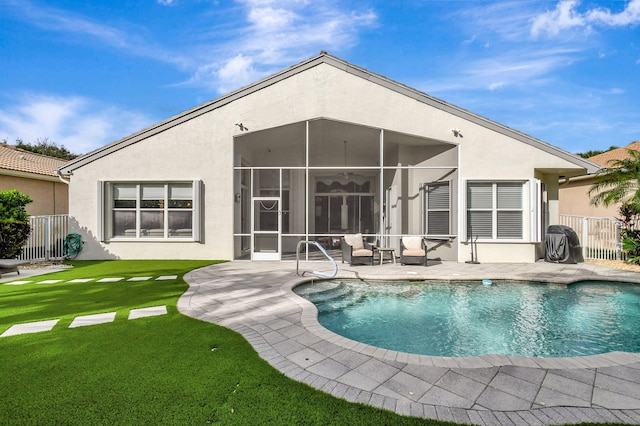 rear view of house with a lawn and a patio area