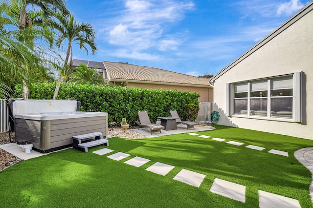 view of yard with a hot tub and a patio area