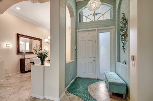 entrance foyer featuring light tile patterned floors and crown molding